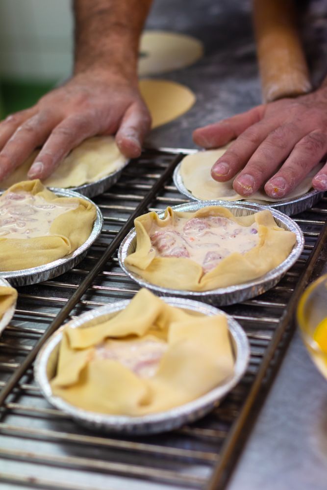 Pie cases being lined with pastry
